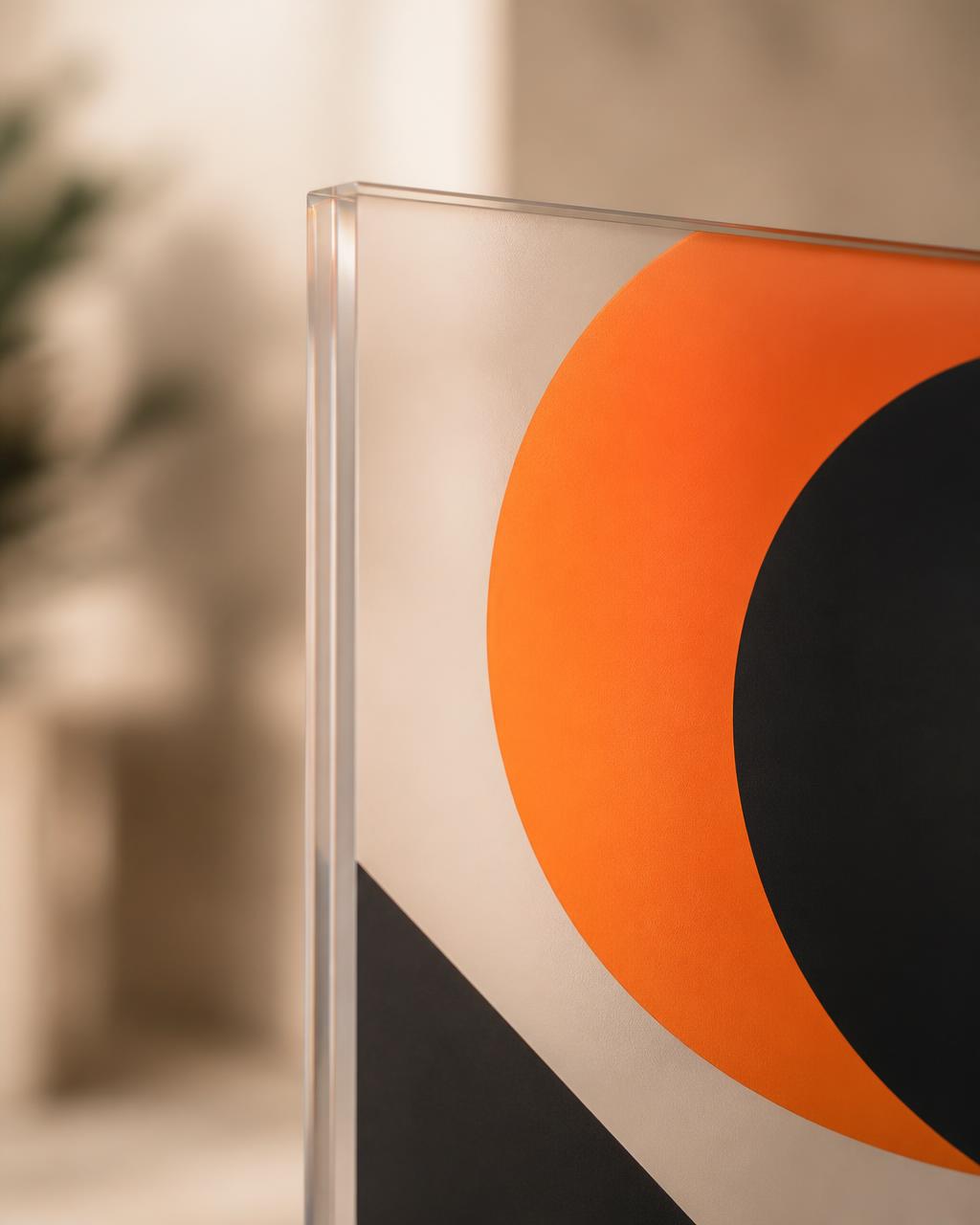 Close view of the corner of an acrylic panel with an abstract orange and black graphic